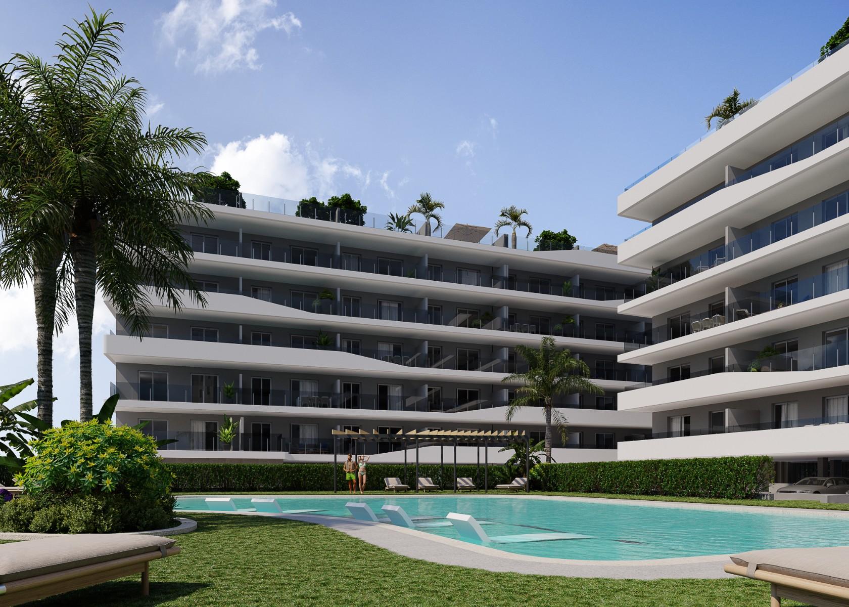 Aerial view of a modern residential complex with a swimming pool near the beach and golf courses in Costa Blanca, Spain.