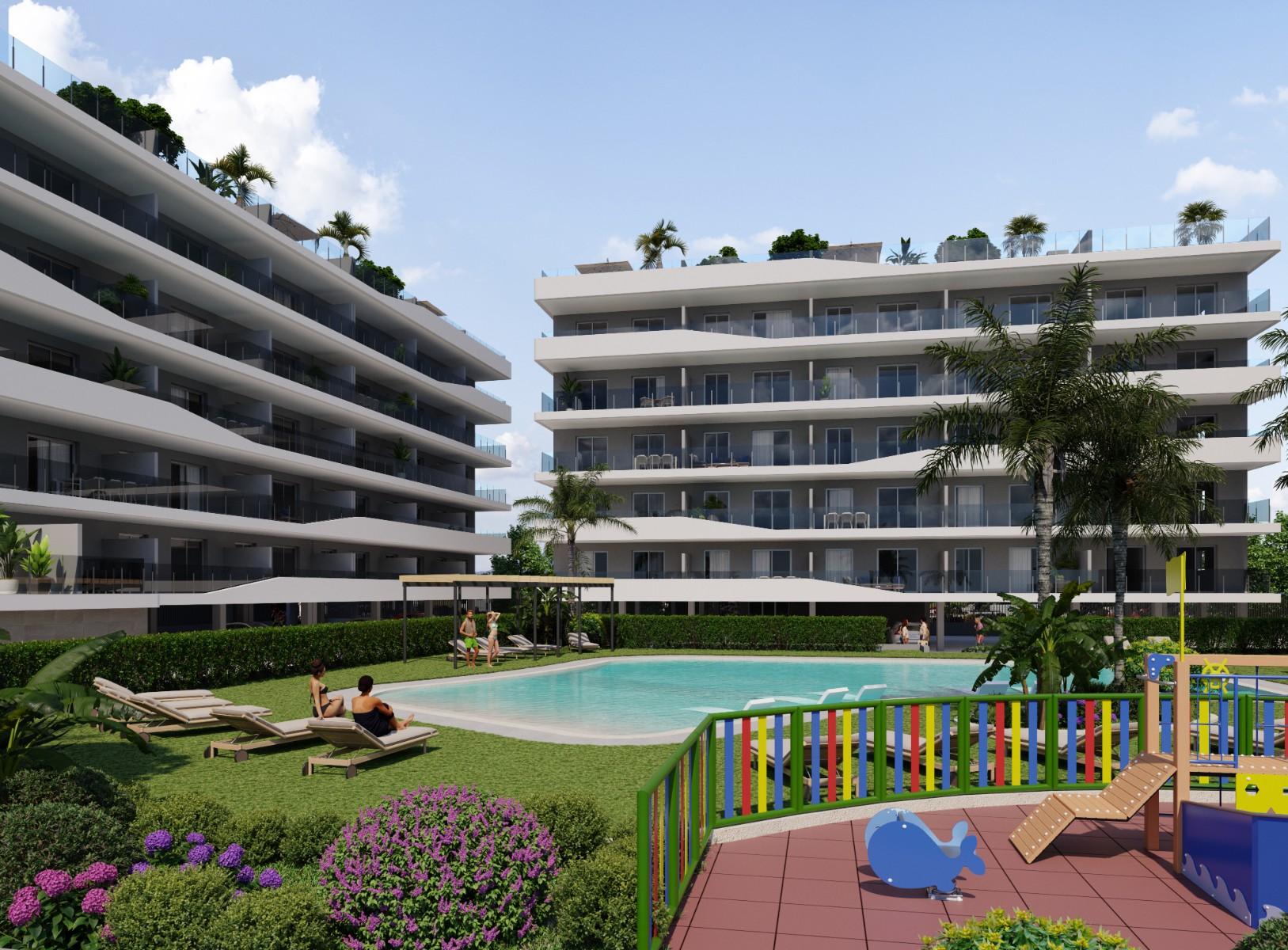 Aerial view of a modern residential complex with a swimming pool near the beach and golf courses in Costa Blanca, Spain.